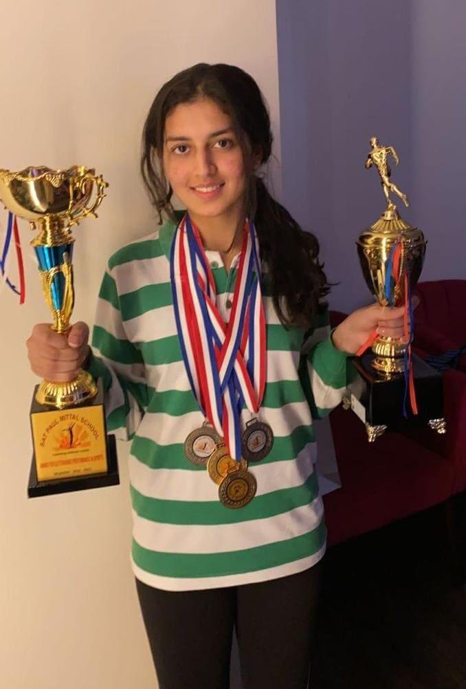 Vaasvi Singal wearing medals and holding trophies